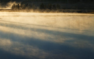 Atmosphere rising from a lake on a cool sunrise morning