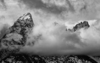 storm breaks over high mountain peaks winter