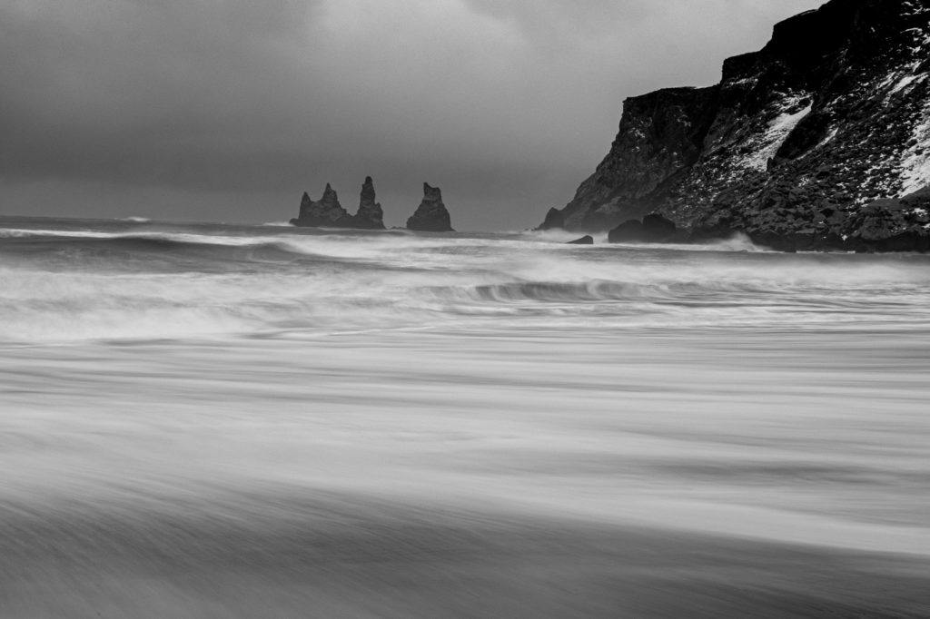black and white ocean beach sea stacks Vik on winter photo workshop in Iceland
