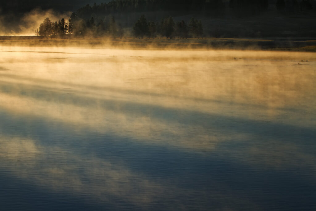 Abstract of fog with golden light and blue water