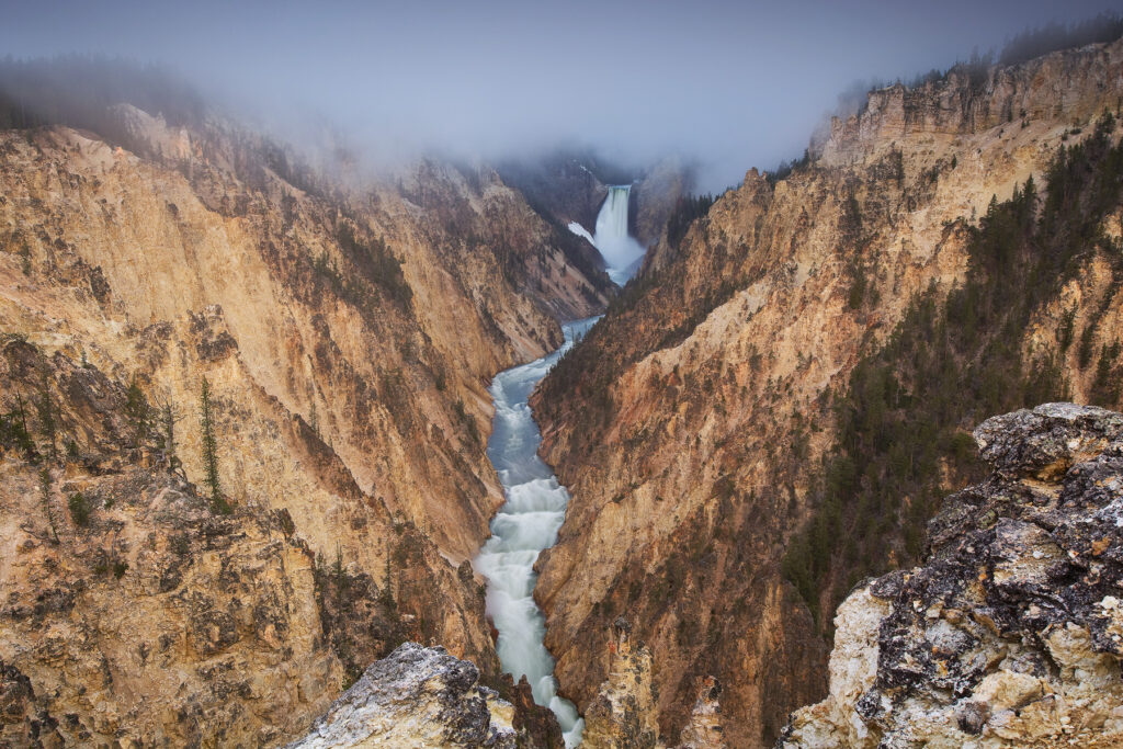Fog over waterfall in Yellowstone National Park