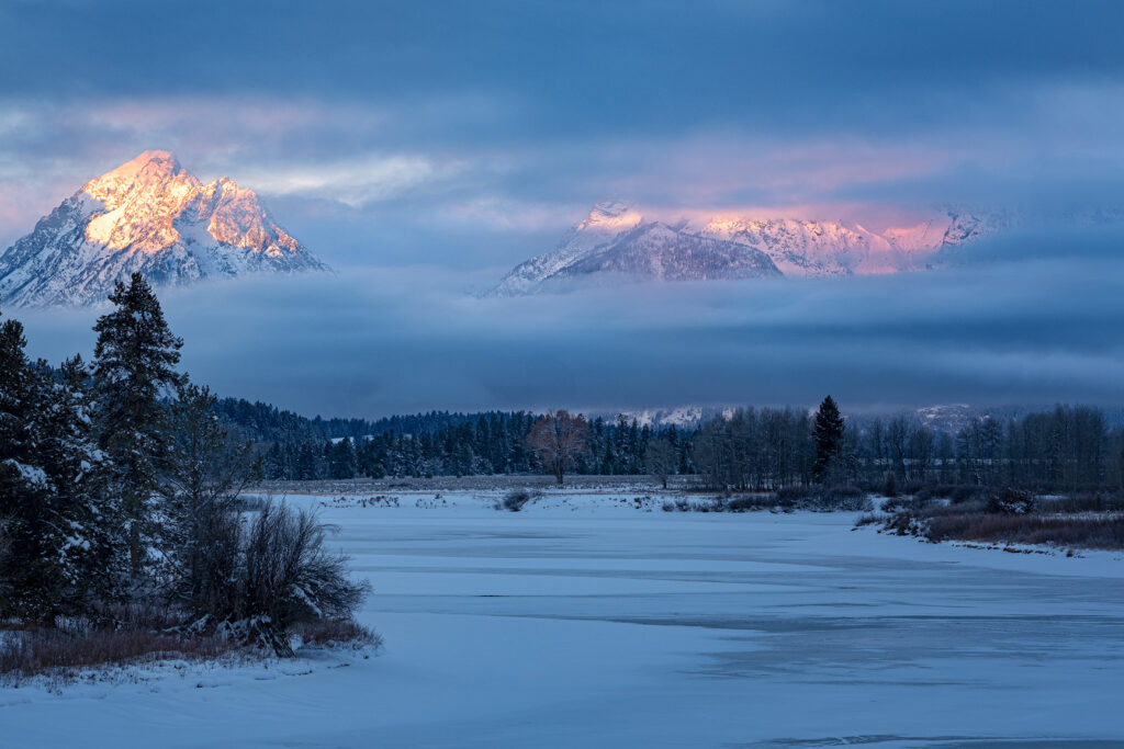 fog and clouds covering Mt Moran and Tetons in winter