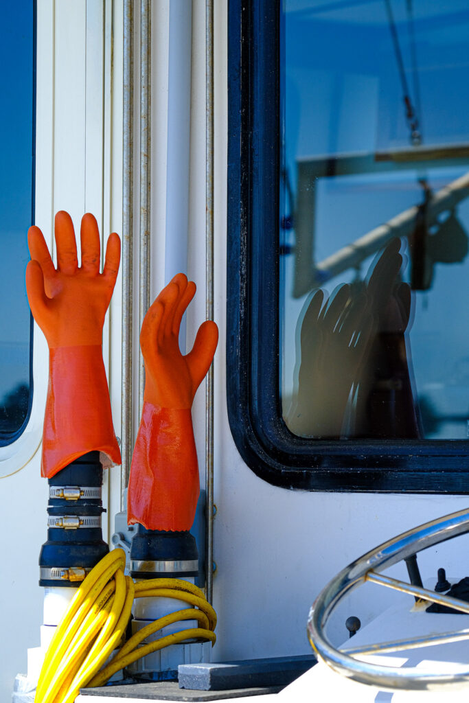 rubber gloves on the deck of a fishing boat