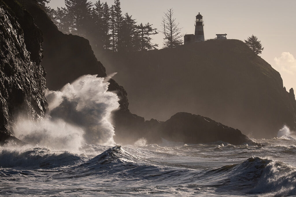 Lighthouse along a rocky coastline with waves breaking