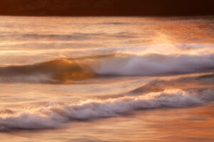 sunset along the pacific ocean with waves