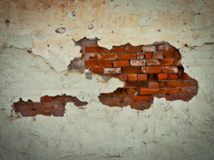 decaying and crumbling brick wall