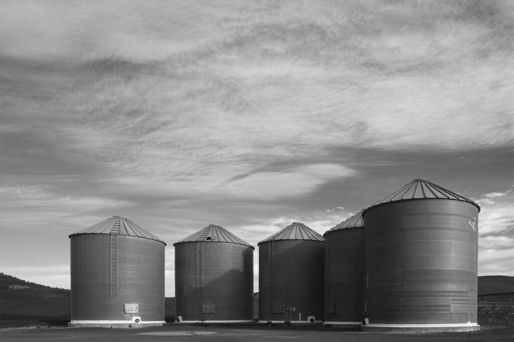 Grain silos lined up with clouds in the sky in the palouse