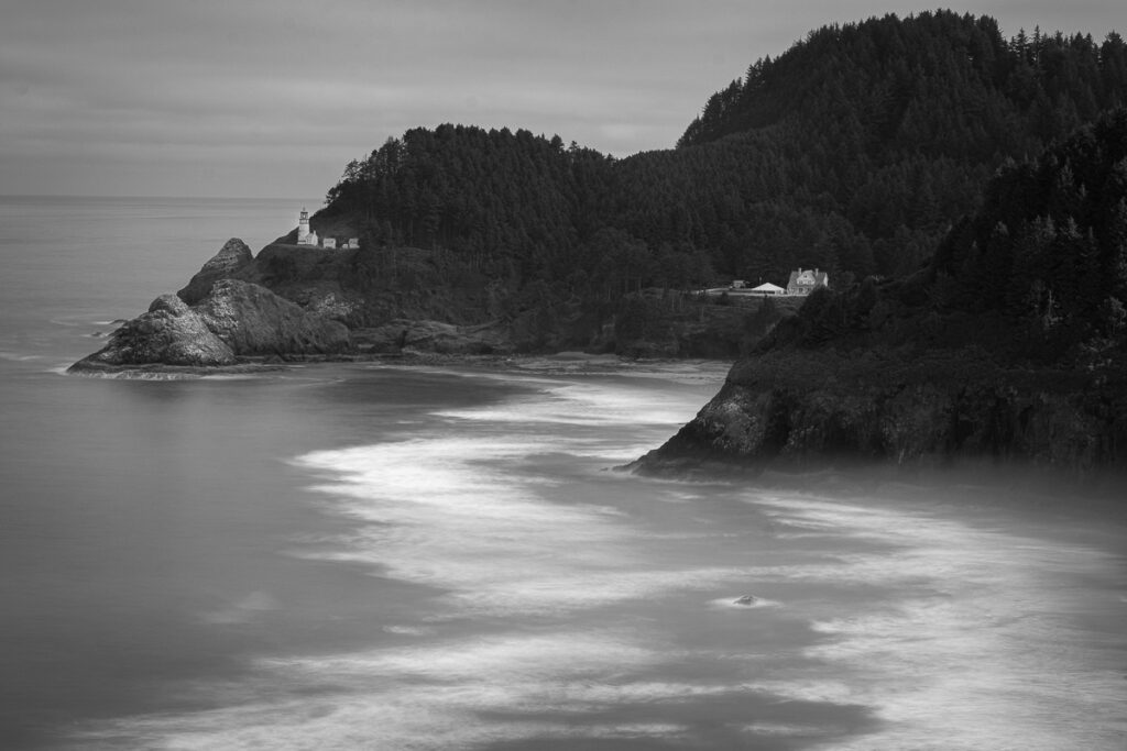 A long exposure of a lighthouse and ocean waves along the Oregon Coast