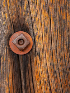 Macro photo of wood and a rusted nut