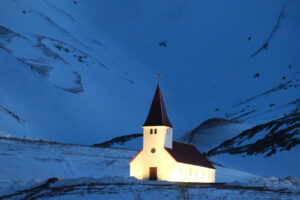 A church in Vik stands on a hill in the pre-dawn hours