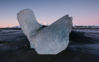 An iceberg shape cradles a distant mountain in Iceland