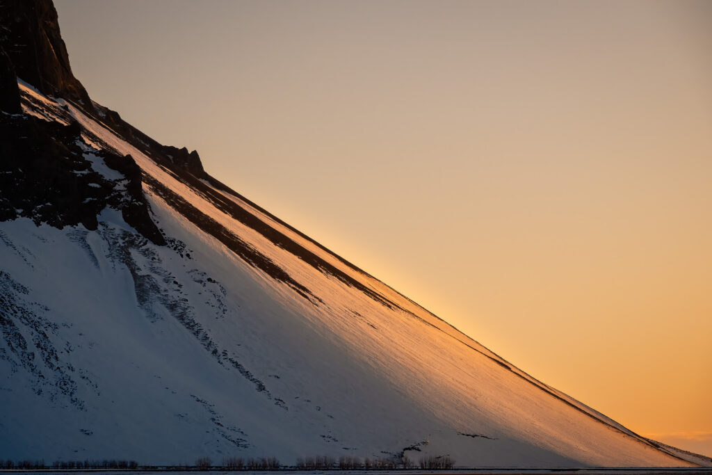 sunlight on the side of a mountain in Iceland during winter