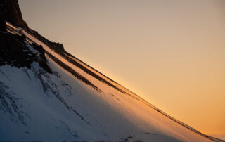 sunlight on the side of a mountain in Iceland during winter