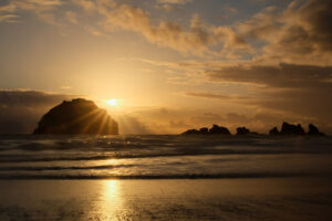 Face Rock in Bandon Oregon with a sunstar and clouds
