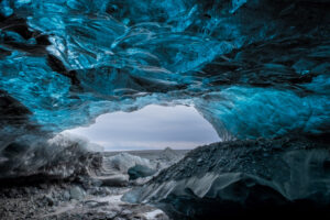 The entrance to an ice cave under a glacier in Iceland during winter.