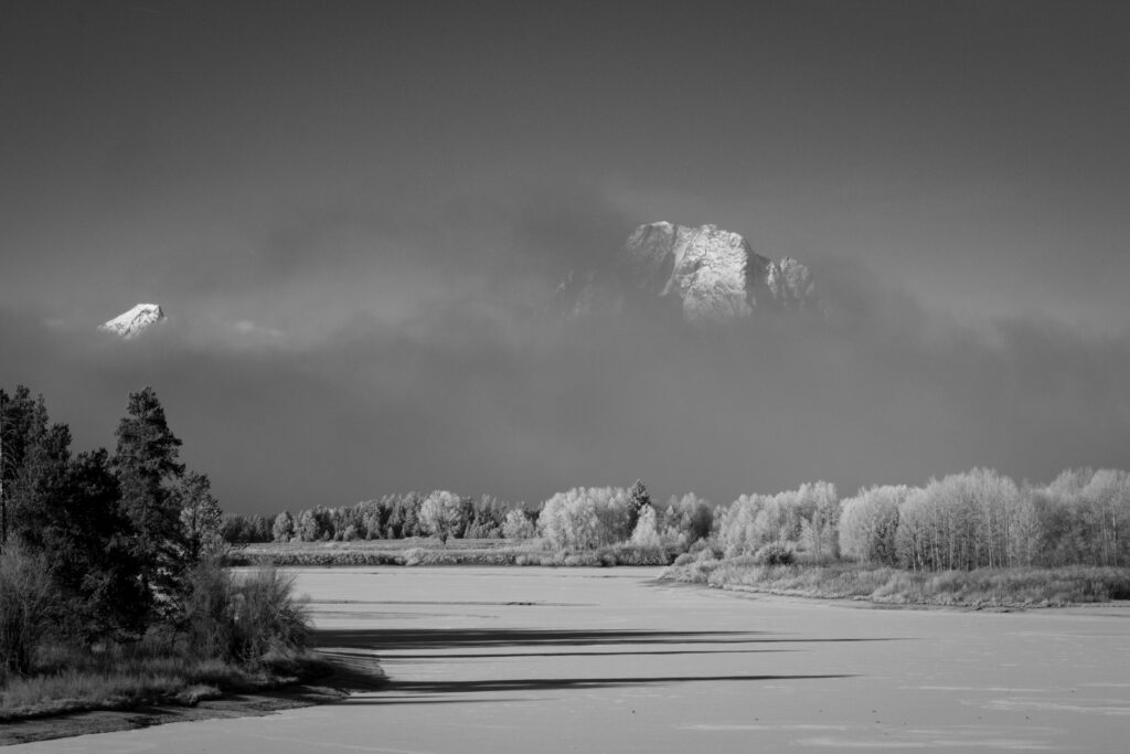 Mt Moran peeks from behind the fog at Oxbow Bend in Grand Teton National Park