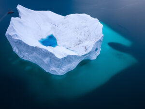 Massive iceberg and sailboat in Greenland