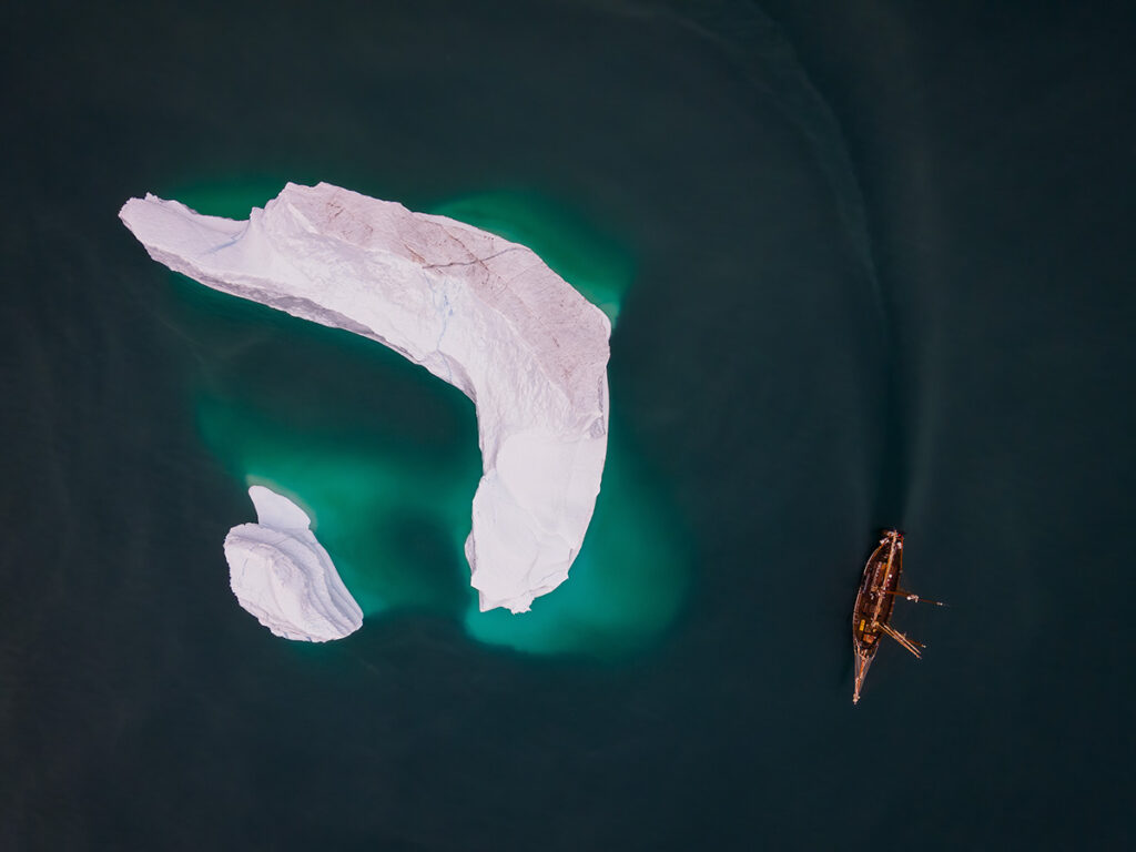 sailboat and iceberg in Greenland