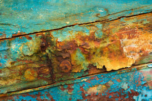 Abstract photo of peeling paint on the side of a boat.
